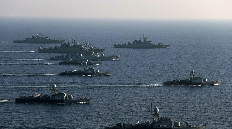 An archival photo of Iranian naval warships patrolling during a maritime exercise in the Middle East, representing current US-Iran military tensions